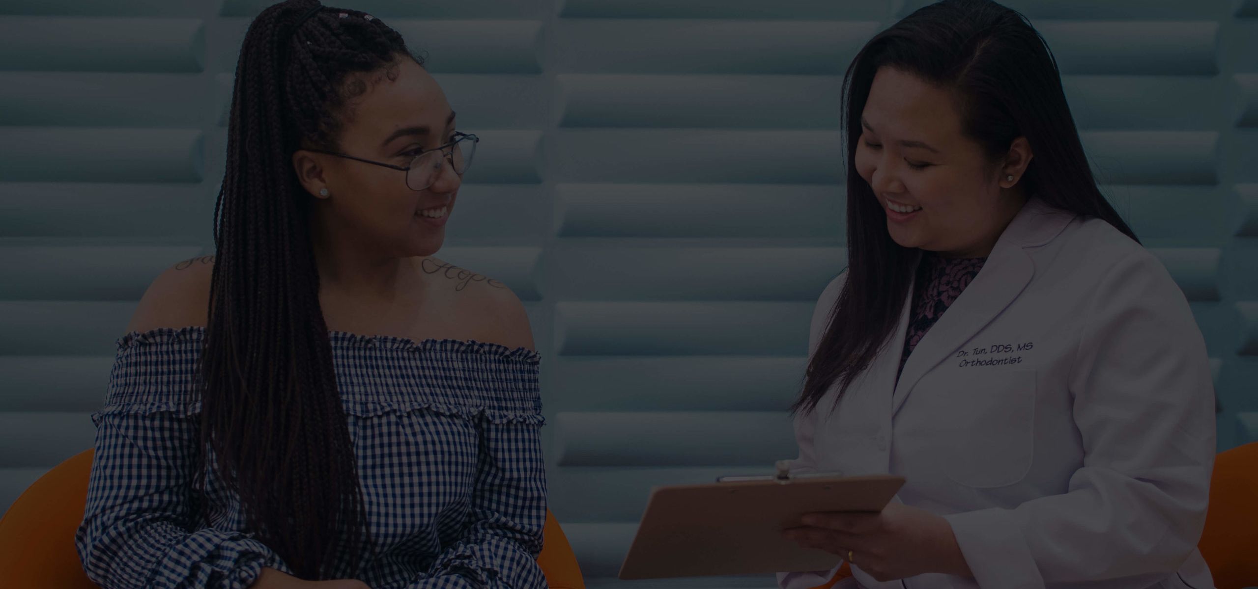 orthodontist talking to patient about braces options